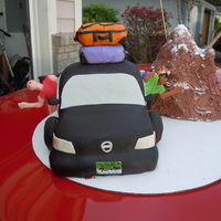 Road Trip Cake Car is cake covered in fondant, people are made out of modeling chocolate, mountain is rice krispy covered with buttercream, suitcases are...