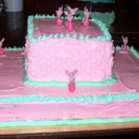 Pink Piglet Cake This is a sheet cake and 3 square cakes stacked on top covered in pink icing and outlined in mint green icing with mini piglets around the...