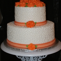 Orange Roses Wedding Cake 2 tier marble cake iced all in buttercream, then overpiped with cornelli lace, fondant ribbon, buttercream roses. This one was my first...