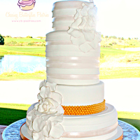 White And Pearl Wedding Cake With Horizontal Pleats Large Petal Flowers And A Gold Pearl Border Accent White and pearl wedding cake with horizontal pleats, large petal flowers and a gold pearl border accent