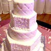 All White 5 Tier Wedding Cake With Quilting Detail And Hand Piped Scroll Work All white 5 tier wedding cake with quilting detail and hand piped scroll work
