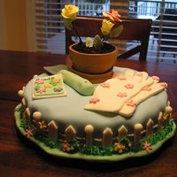 Gardening Fondant covered cake with gumpaste accessories (spade, seed packet, etc).