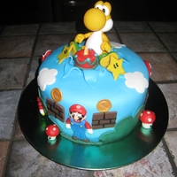 Yoshi Cake This cake was done for a little boy who loves Super Mario Bros especially Yoshi. The little cake was lite up.