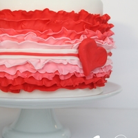 Valentine's Ruffle Cake 6" strawberry cake filled with vanilla swiss meringue buttercream. Decorated with fondant, ombre ruffles.