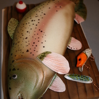 If You Can't Catch One...make One! For our friends birthday who loves to fish. Cutting board is one layer of chocolate with brushed fondant. Fish was carved, covered in...