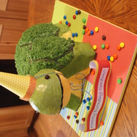 Turtle Pillow Pet Body is cake, covered in buttercream. Head is styrofoam covered in buttercream, hat , cake board and birthday banner are scrap paper.