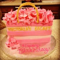 Victoria's Secret Bag Cake * Red Velvet with Cream Cheese frosting. Tissue paper made of fondant, handles made of gumpaste and Victoria's Secret letters made of...