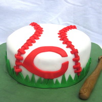 Baseball Cake This is a chocolate cake covered in fondant with fondant accents. It is a 6 inch round because cupcakes are being provided so this is just...