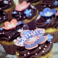 Birthday Flowers Chocolate chip cupcakes with whipped ganache filling and ganache icing. Flowers are made from white modeling chocolate. TFL