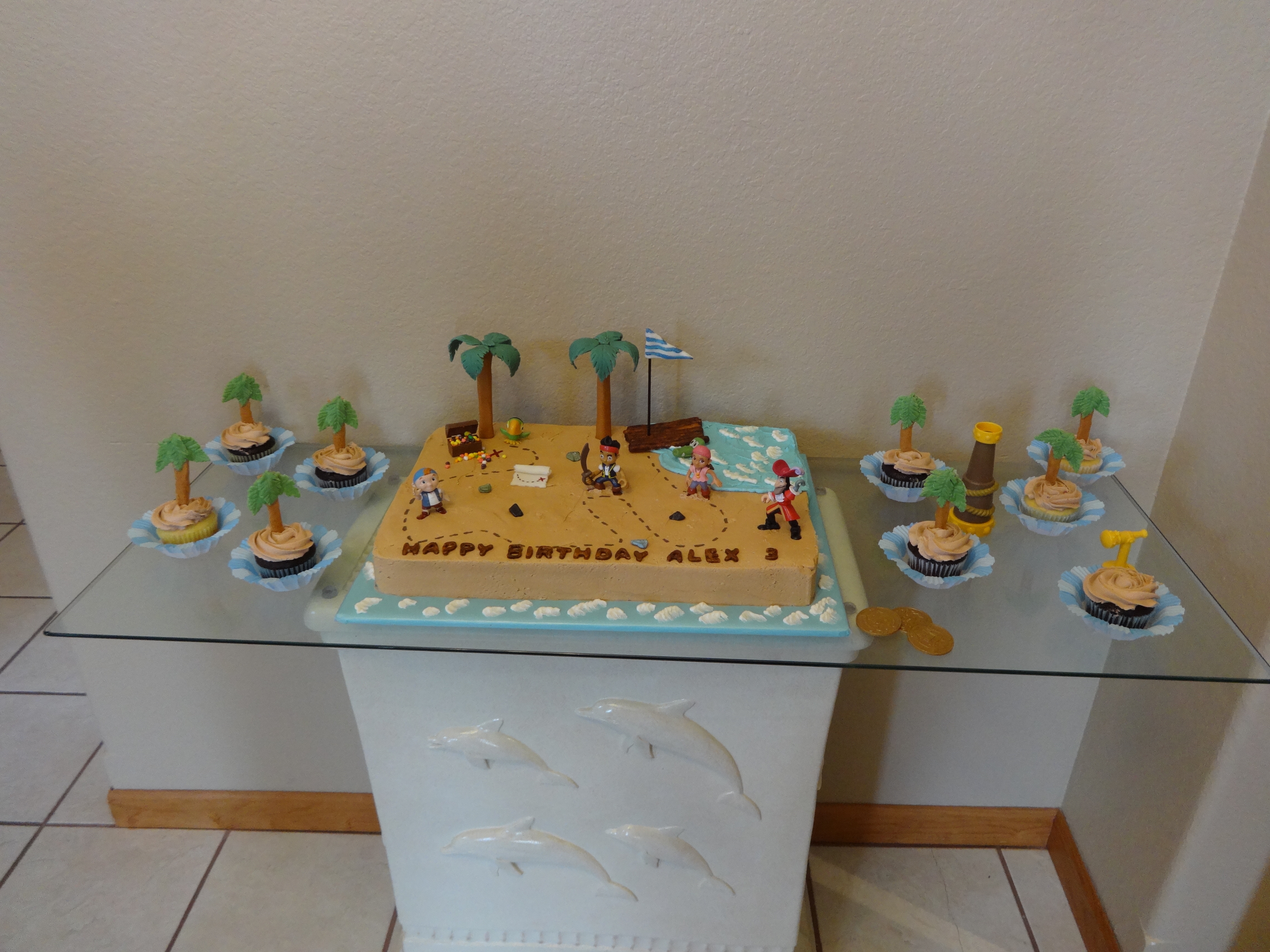Jake & The Neverland Pirate Cake Chocolate Fudge & French Vanilla half sheet cake with buttercream. Palm trees, raft and croc are fondant. Jewels are Nerds candy. The...