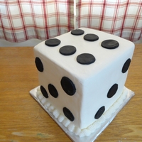 Dice Cake 4 layers of chocolate Cake with Raspberry filling, buttercream filling, and cookies & cream filling. Cake covered with modeling...