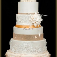 Glam And Shine Wedding Cake Stones Are Not Edible Flower Is All Edible Icing Desing Repeating Lace Pattern From Brides Dress Glam and shine wedding cake. Stones are not edible. Flower is all edible.Icing desing repeating lace pattern from bride's dress.