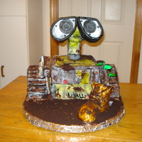 Wall-E Made for 2-y-o fan of Wall-E. Wheels, body, and shoe are cake. Head and arms are fondant-covered styro. Mud and dirt is chocolate...