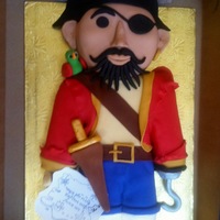 Pirate Cake A friendly pirate cake that was carved from cake and dressed in fondant. His hook and sword handle are dried and painted gumpaste. His...