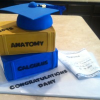 Graduation Books, Cap And Diploma Fun grad cake done for a friend, cap was ball pan and card board covered in fondant. Edible paper diploma.