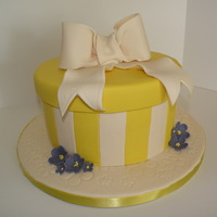 Spring Time Hat Box Cake Hatbox inspired cake. Bow and flowers are a 50/50 mix. Cake is fondant. Extra flower detailing on the cake board. Loved how feminine it...
