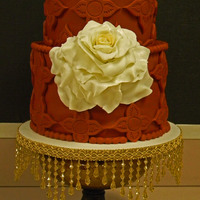 Spanish Style Wedding Cake Fondant covered cake with Gumpaste Rose (rose center is dusted with gold, rose petals dusted with pearly white).