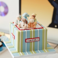 Stuffed Animal Party Gumpaste figurines on top of Red Velvet Cake with White chocolate Ganache Frosting