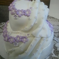 Flowered Drapes Carrot Cake with Cream cheese frosting, covered and decorated with Fondant.