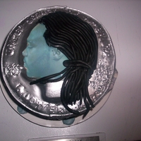 Coin Cake THIS WAS A UNIQUE CAKE. MY CLIENT WAS TURNING 25, SO I DECIDED TO IMAKE HIS FACE ONTO A QUARTER. HE WAS BLOWN AWAY