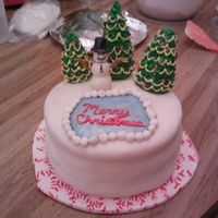 Christmas Cake This is a 8 in round double layer, mt dew cake, with mt dew buttercreme. The trees and decor are made out of modeling chocolate.