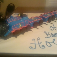 Thomas The Train Baked Thomas in a Bread Loaf pan, and the cars in mini loaf pans. Cakes are strawberry with butter creme icing. Face is the only thing...