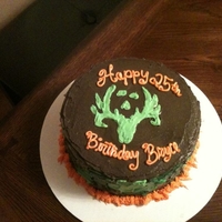 Bone Collector Cake This was a White Cake, that was tinted different camo colors, and baked in camo layers. The icing is Vanilla Buttercreme Tinted. The Logo...