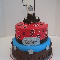 Western Themed First Birthday Cake This cake was made for a first birthday. The top layer is all buttercream and the bottom is fondant and modeling chocolate.
