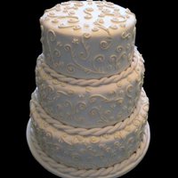 Scroll 3 Tier Wedding cake covered in Fondant with Royal Icing Scroll Work and Fondant rope border