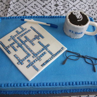 Crossword Puzzle And Accessories Cake for my Father-in-Law's 70th birthday. He is a crossword fanatic. All is edible, except the sentiments on the coffee cup. I'm...