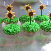 Sunflowers Buttercream grass, wooden skewer stem, fondant flower