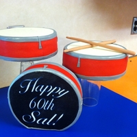 Drums Birthday Cake Drums are pound cake filled with bavarian cream, buttercream icing finished with fondant. Fondant drum sticks.