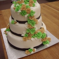 Tan And Lime Green Wedding Cake 3 tier round wedding cake. Fondant covered, fondant ribbon and buttercream piped flowers.