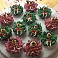 Red Velvet Cupcakes With American Buttercream Frosting And Royal Icing Eyes And Mouths Red velvet cupcakes with American buttercream frosting and royal icing eyes and mouths.