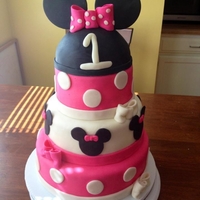 Minnie Mouse Cake Chocolate, vanilla, and strawberry cake covered in marshmallow fondant with gumpaste ears.