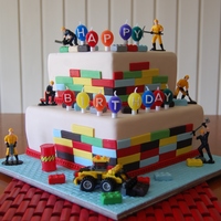 Seth Choc mud and choc mint mud cake. Covered in fondant. Lego blocks made from fondant/gumpaste mix. Lego Toy loader sitting at base....