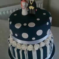 Navy & White Round Wedding Cake Navy & white round wedding cake. 2 tiers of chocolate and madeira with a handmade gumpaste topper. My first proper wedding cake.