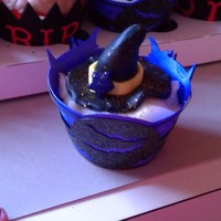Witch's Hat Cupcakes These toppers are made of fondant. I also made the wrapper in a witch themed background.