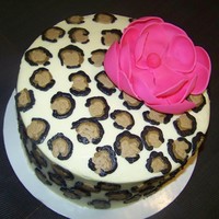 Ruby Leopard Leopard print done in buttercream frosting with a fondant magnolia flower topper.