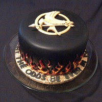 Hunger Games Chocolate fondant covered 8" with red velvet cake and cream cheese filling. Handcut gumpaste mocking jay and piped flames. For our...