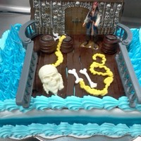 Pirates Buttercream frosting. The ring, pirate, wall, and railing are toys