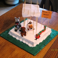 Melissa's Zoo My 9 yr old granddaughter wanted to make some fondant animals. She made the little square cake, frosted and edged it and I helped her line...