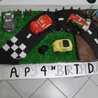 Cars 2 - Racing To The Finish Line! My son's 4th birthday cake in Cars 2 theme. 2x12" square cakes (one vanilla and the other chocolate) with an 8" white...