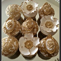 Rococo Cupcakes A collection of elaborate Rococo inspired gold and ivory fondant wedding cupcakes with edible sugar brooches & flowers hand painted...