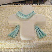 Baptism Cake 3D cross covered in fondant on sheet cake decorated with cornelli lace design