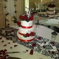 Wedding Cake Wedding cake done with fondant, roses, and baby breath. Three teir cake, with rose peddles on the table. very beautiful wedding.