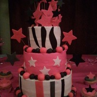 Sweet 16Th Birthday Cake for a sweet 16th with cupcakes. Butter cream icing with fondant decorations.