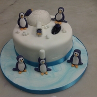 Penguins Having Fun! This cake captures an image of penguins having fun - sliding off the igloo and more.