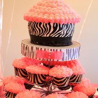 Zebra Cupcake Tower giant cupcake (for the birthday girl) and regular cupcakes.....Part of a dessert bar I created for my daughter's 2nd birthday that was...