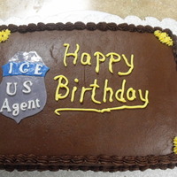 I.c.e. Agent Chocolate on Chocolate buttercream. Badge is fondant and gumpaste.